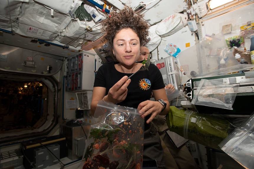 Astronaut eating a plant 