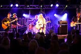 Felicity Urquhart performing on stage at the Groundwater Country Music Festival with her band