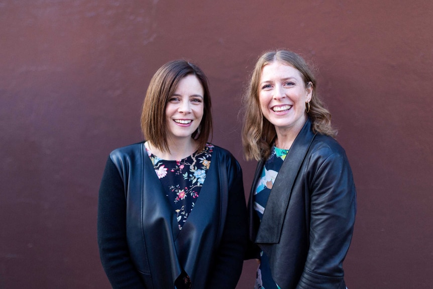 Clare Jacobsen and Catherine Schweitzer smile during a photo shoot