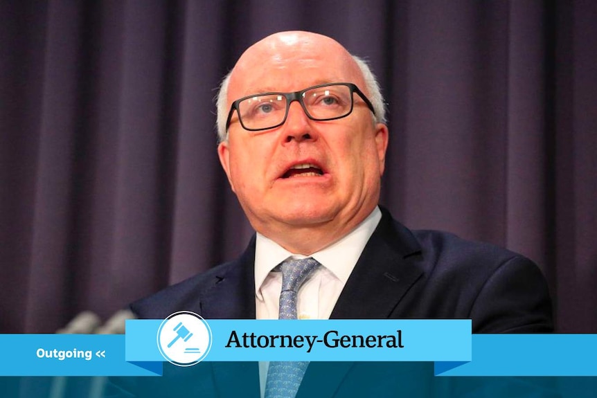 George Brandis with Attorney-General banner.