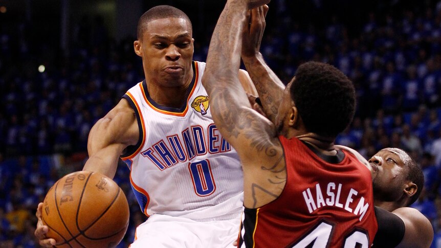 Sizzling display ... the Thunder's Russell Westbrook (L) evades Udonis Haslem (C) and Dwyane Wade.