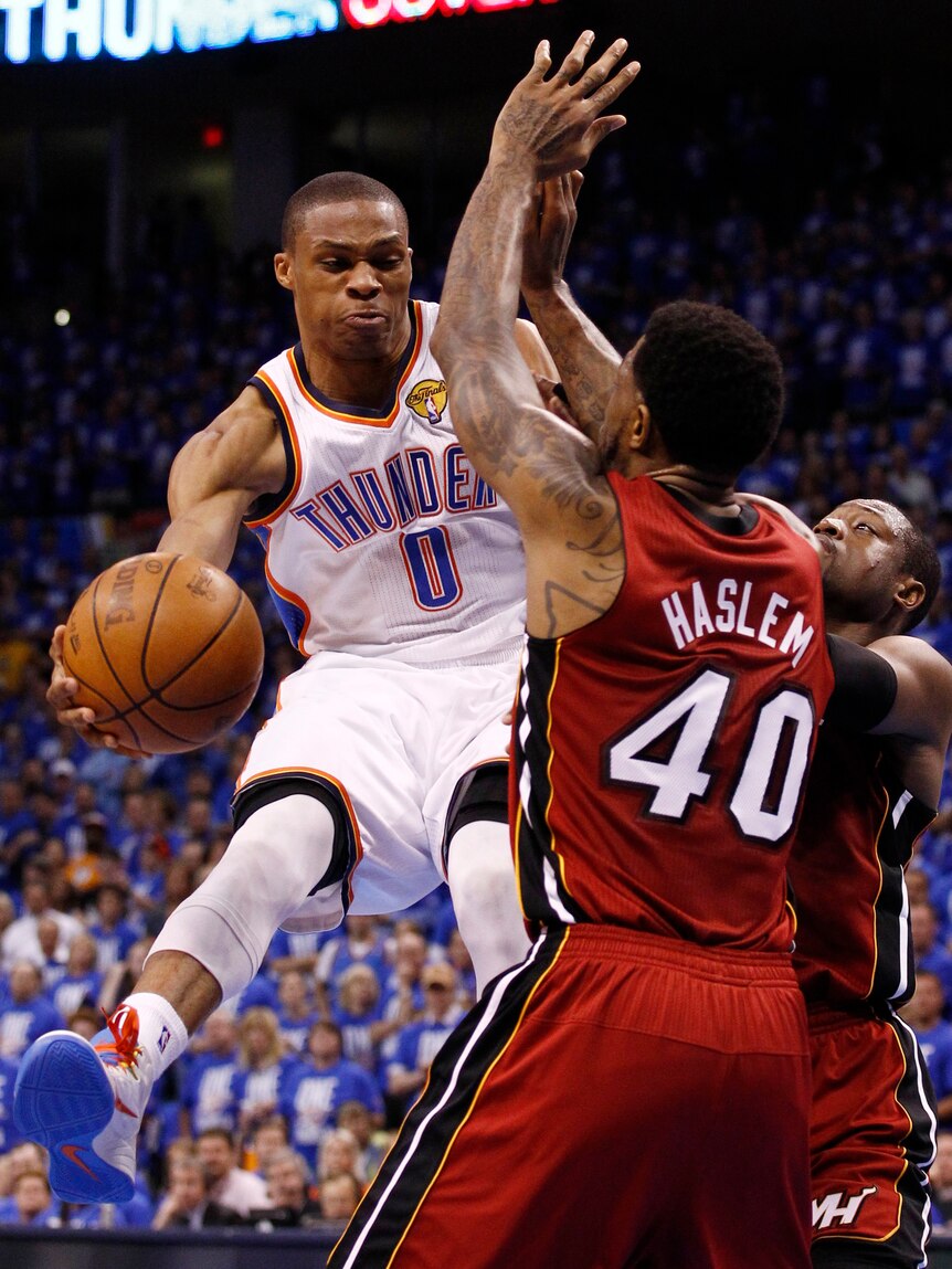 Sizzling display ... the Thunder's Russell Westbrook (L) evades Udonis Haslem (C) and Dwyane Wade.