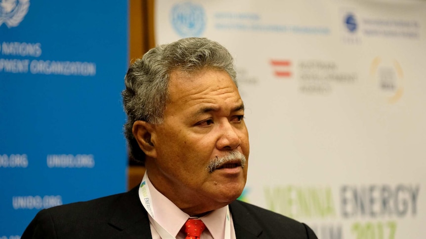 Enele Sopoaga, Prime Minister of Tuvalu stands in front of United Nations logos at an energy forum.
