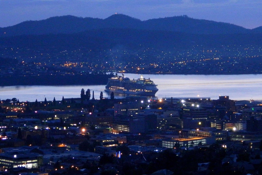 A cruise ship arrives in Hobart just before sunrise.