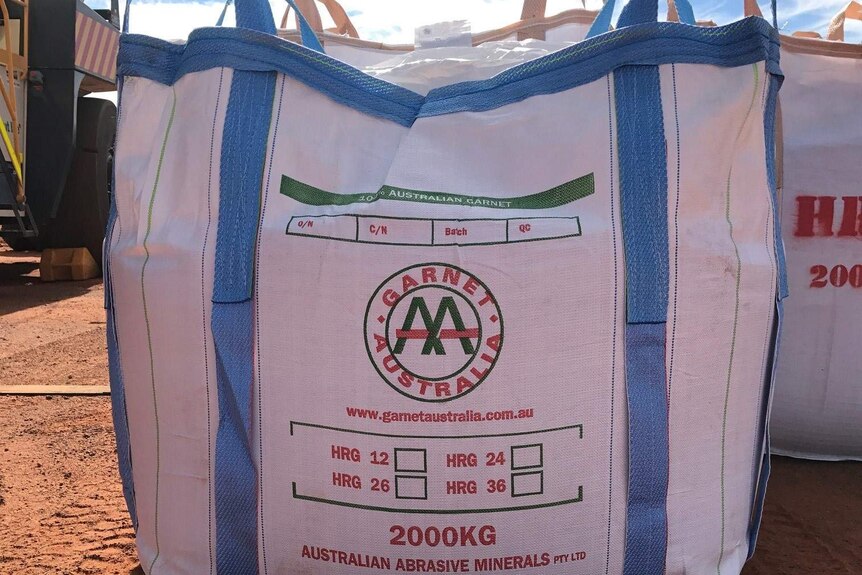 White bag with company's name on it in red letters.