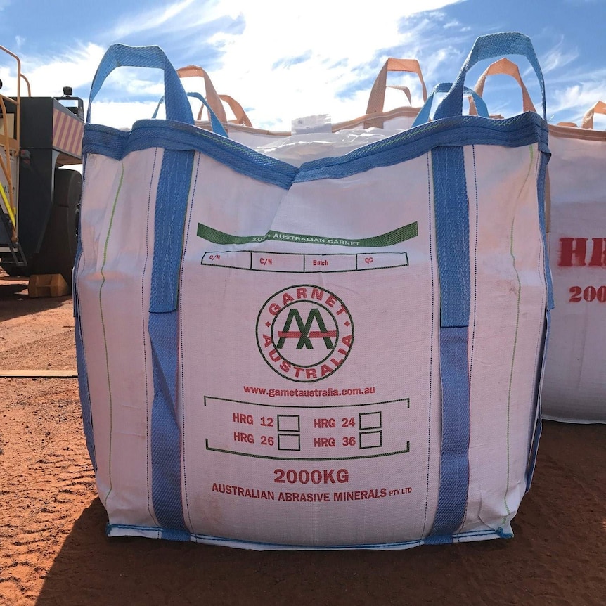 White bag with company's name on it in red letters.