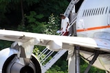 Asylum seekers step from a plane on Nauru after arriving from Christmas Island.