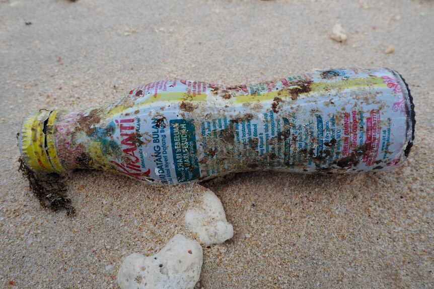 A plastic bottle covered in Indonesian writing.
