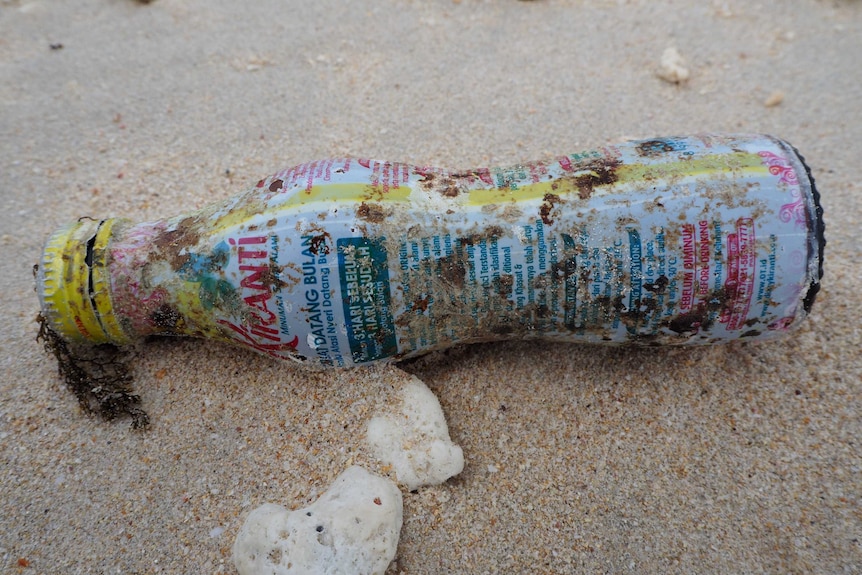 A plastic bottle covered in Indonesian writing.