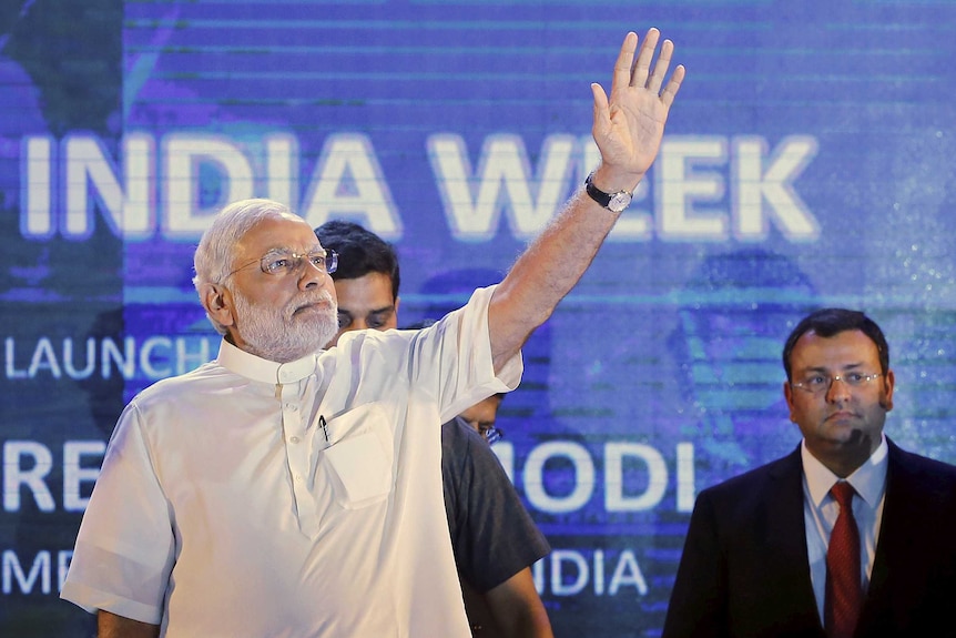 Narendra Modi waves as Cyrus Mistry (R), chairman of Tata Group watches during the launch of Digital India Week