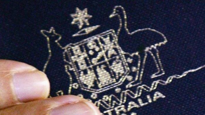 Close-up of hand clutching Australian passport