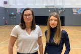 Dr Mary Woessner and Dr Aurelie Pankowiak pose for a photo on one of the basketball courts at Victoria University