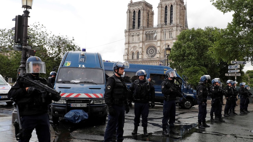 French police stand guard outside the Notre Dame Cathedral.