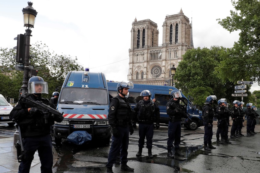 French police stand guard outside the Notre Dame Cathedral.