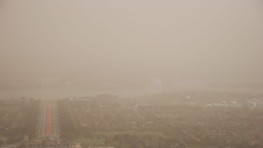 Dusty view: Canberra's icons are difficult to see from Mt Ainslie, even at 2:00pm AEST.