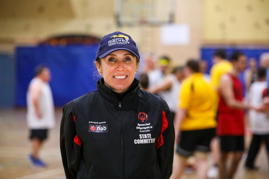 Tanya Brown wearing a navy blue zip-up jacket and cap, both with Special Olympics logos on them