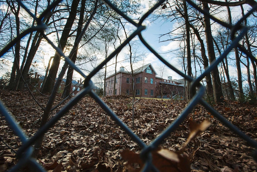 A fence encloses an estate in the village of Upper Brookville.