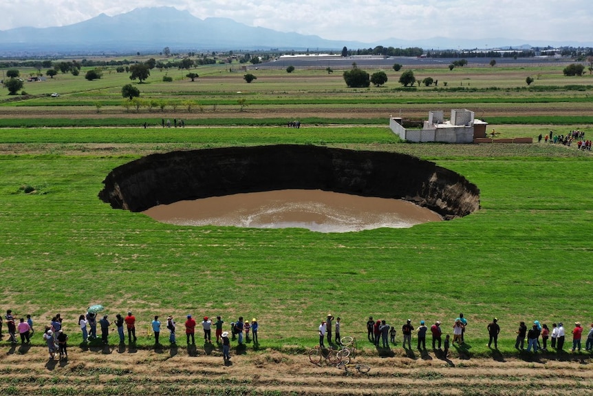 Aerial view of a sinkhole that was found by farmers in a field of crops in Santa Maria Zacatepec.