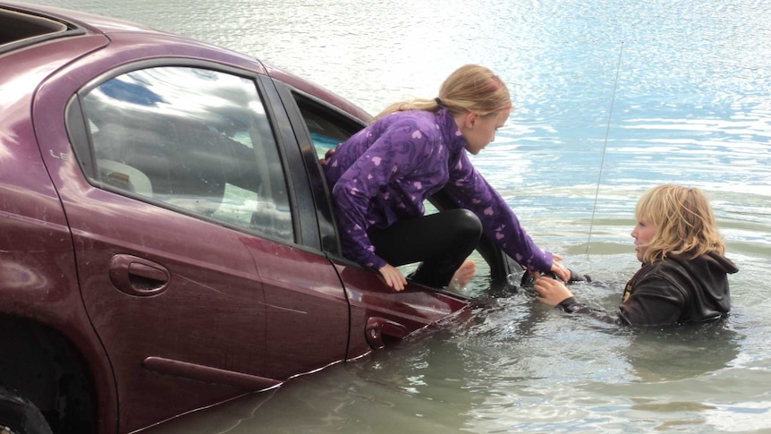 Child escaping sinking car through window