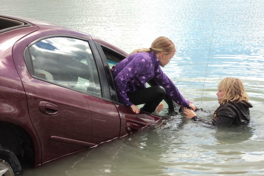 Child escaping sinking car through window