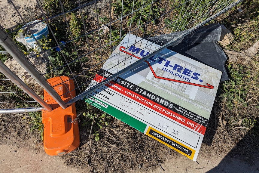 A sign under a wire fence says: Multi-Res Builders