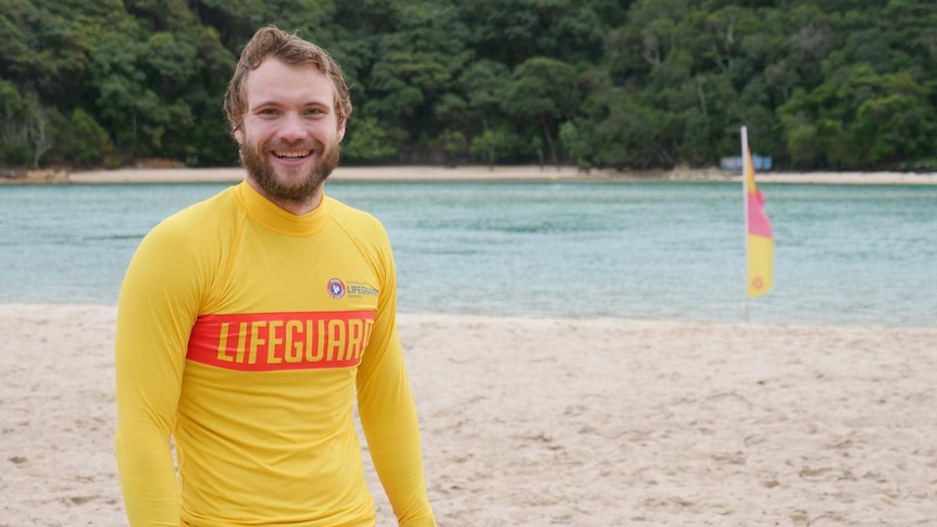 Surf lifesaver Samuel Dick standing at Tallebudgera Beach as he undergoes intense training