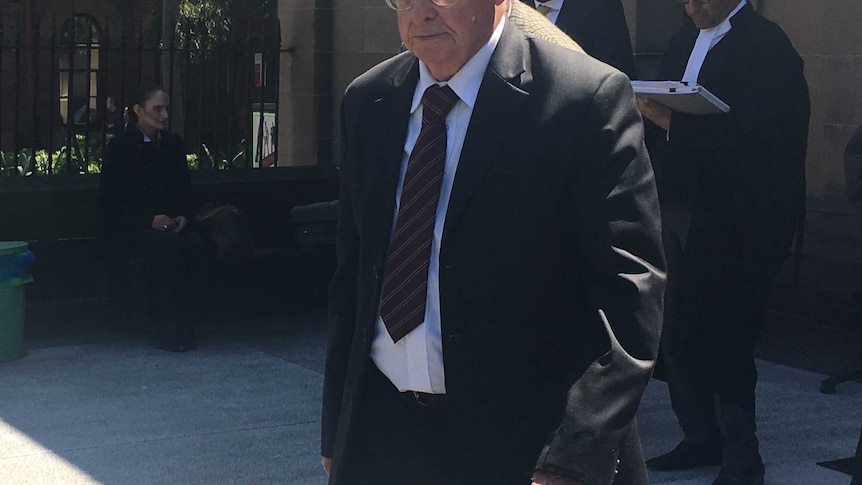 Vincent Gerard Ryan, wearing a suit, walks outside court.