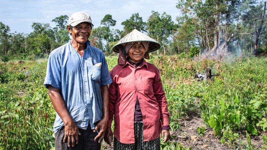 Tet Sorn and his wife, working on their land.