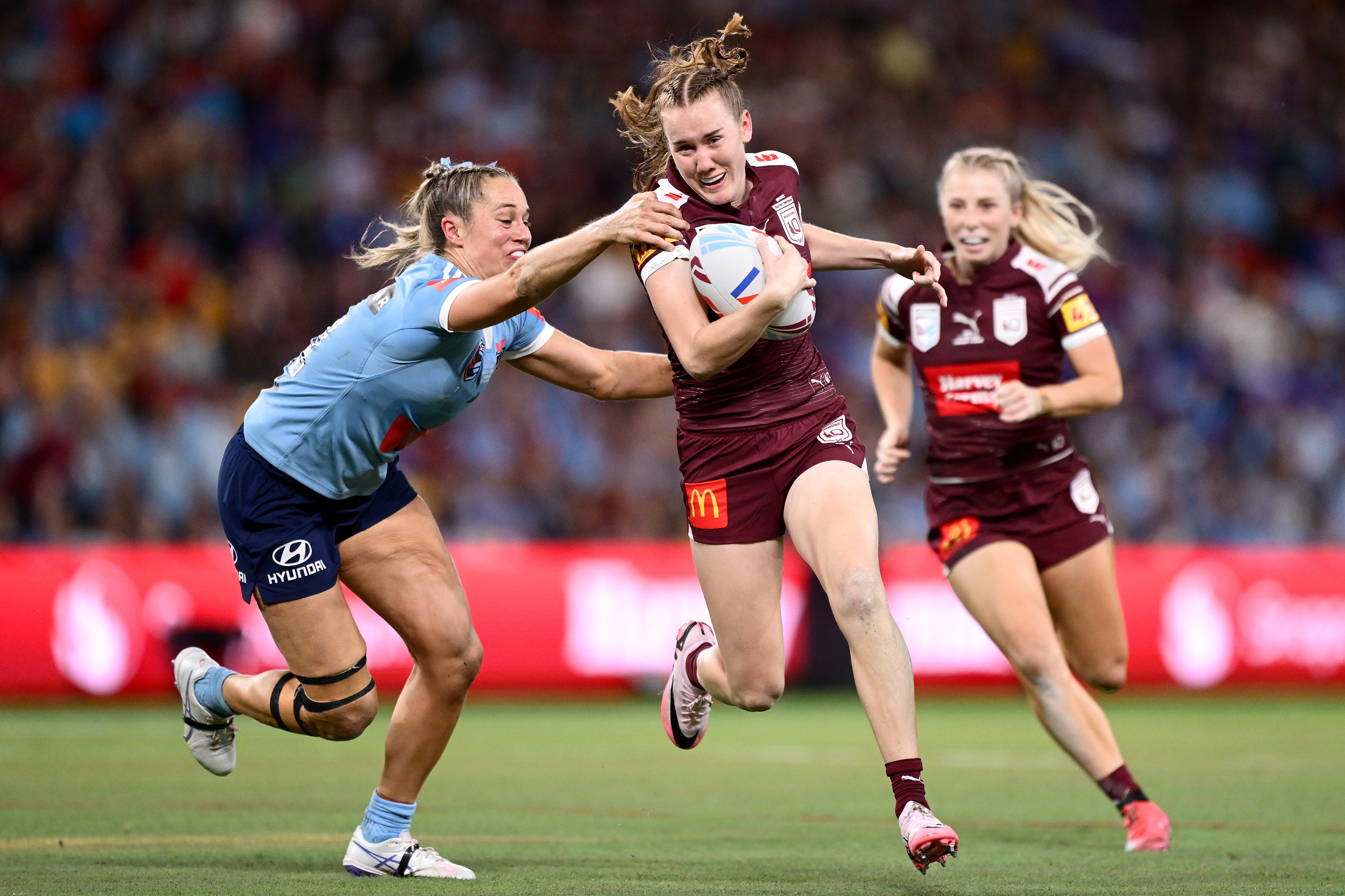 Tamika Upton runs the ball as Kezie Apps attempts to tackle her