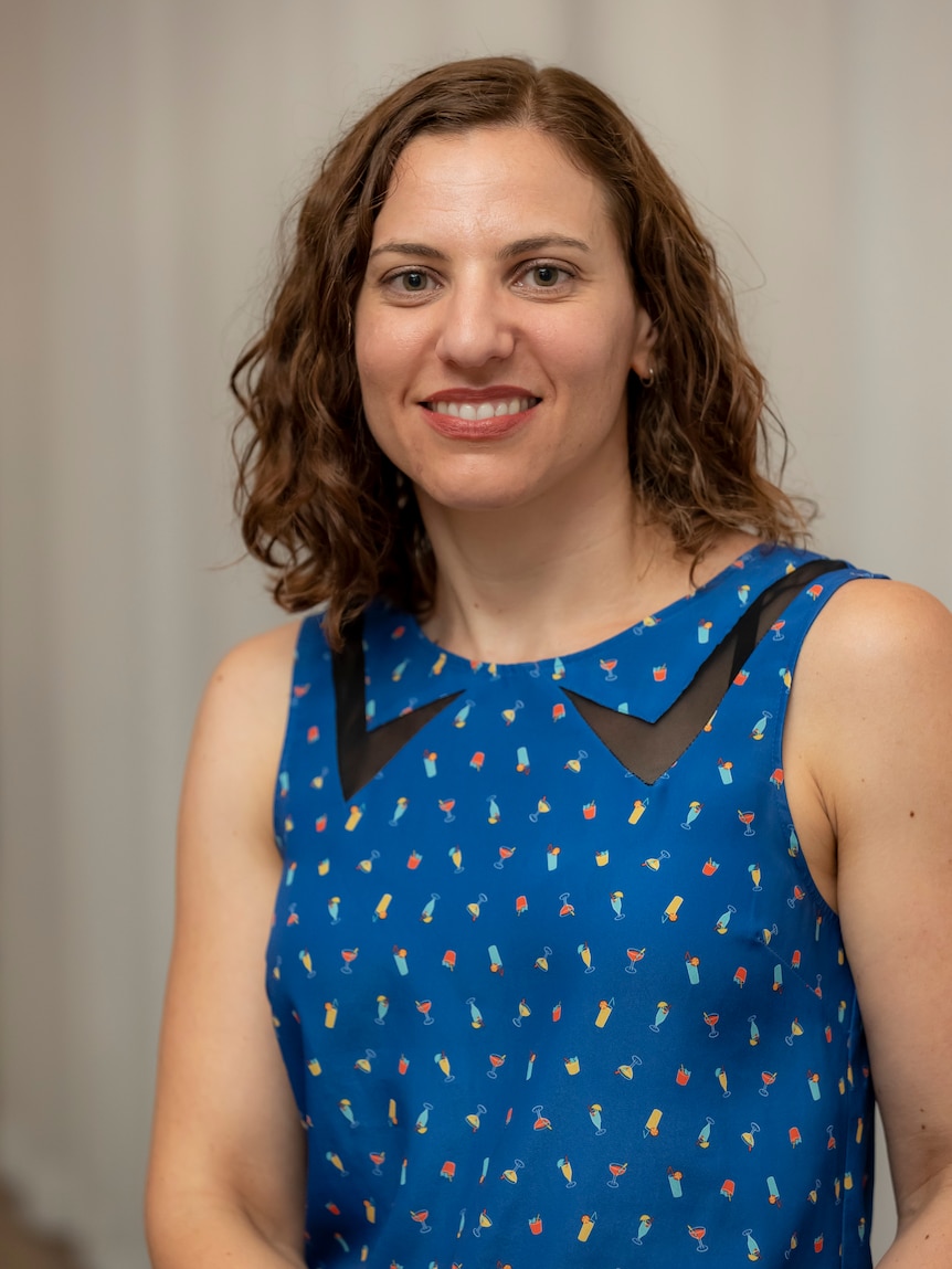 Headshot of a woman wearing a blue shirt