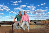 Maree and Rhiley Kuhrt sitting on fence smiling on rural property. 