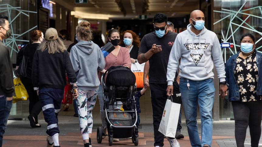 Masked-up people on the street.