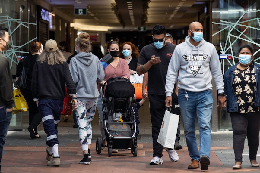 Masked-up people on the street.