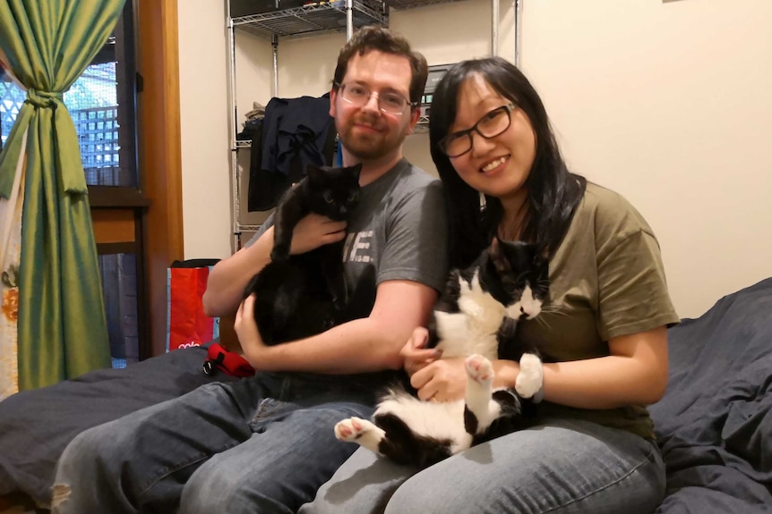 Jenny Zhang and her partner Christian Tornes with their cats.