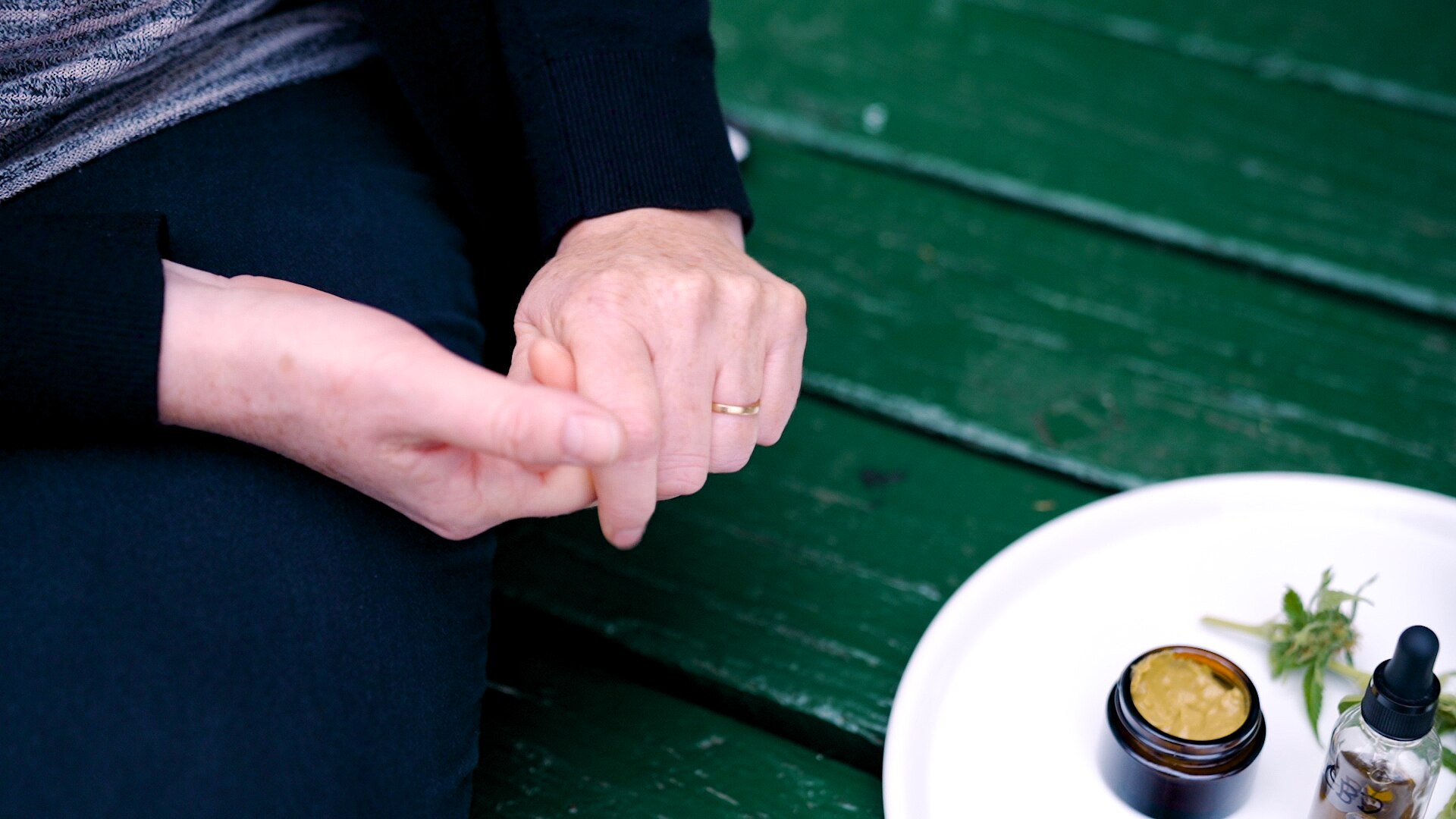Woman&#x27;s hands next to medicinal cannabis products