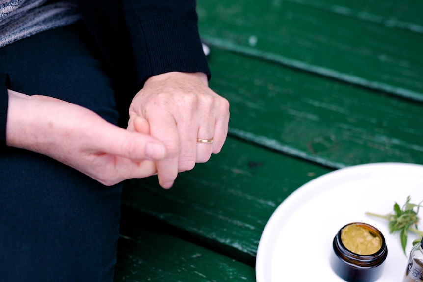 Woman's hands next to medicinal cannabis products