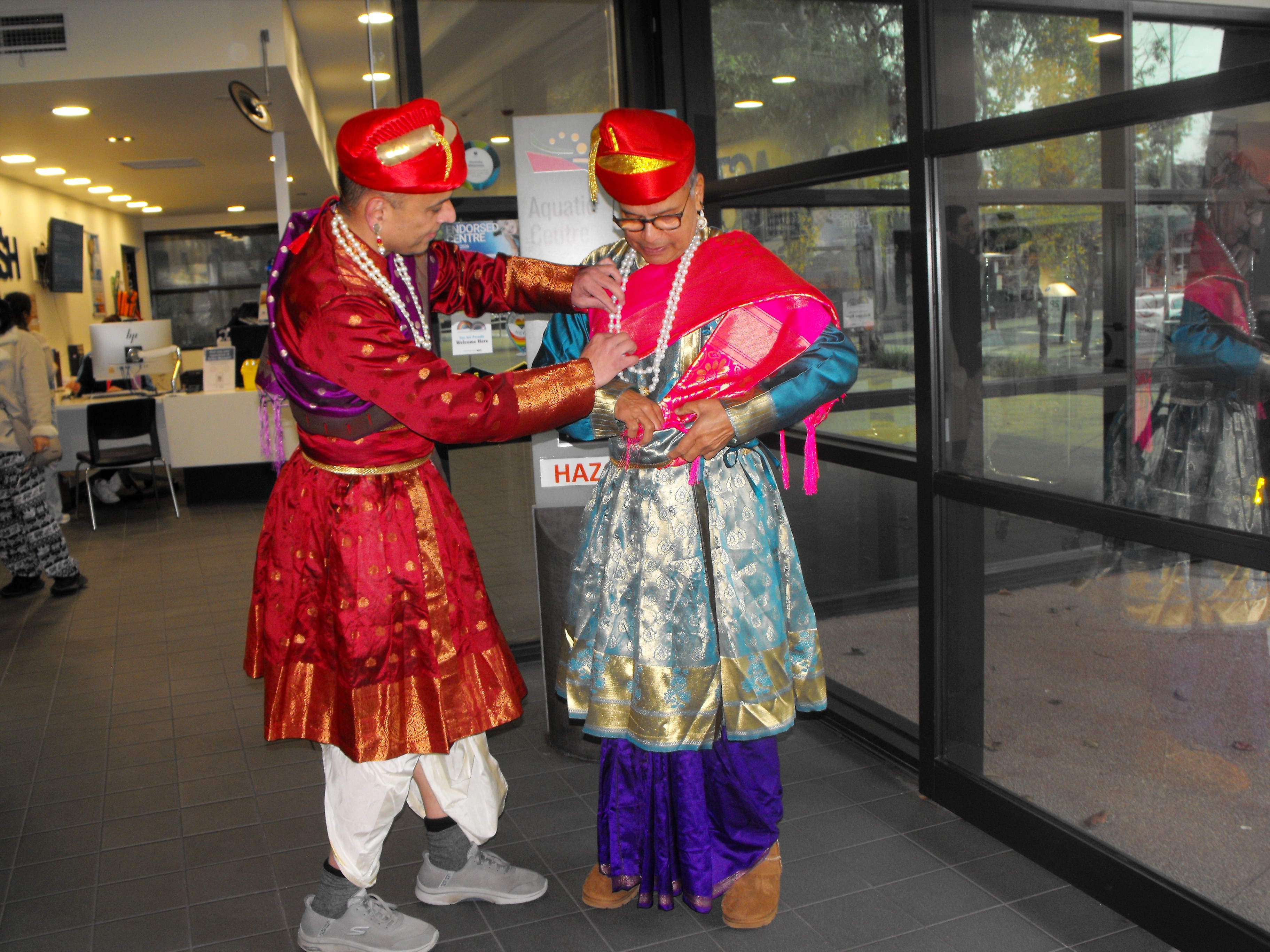 Rishikesh and Madan, wear elaborate and colourful Indian clothes, turban, Madan helps Ris