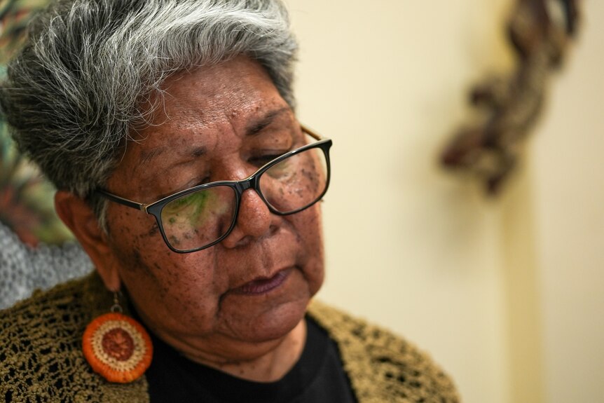 an Aboriginal woman with short grey hair wearing glasses