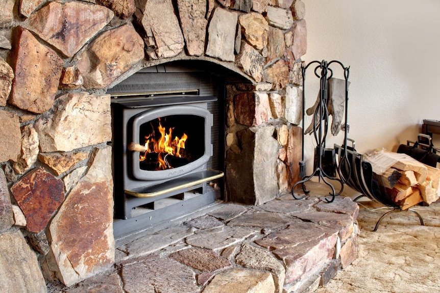 A fire burning in a stone fireplace