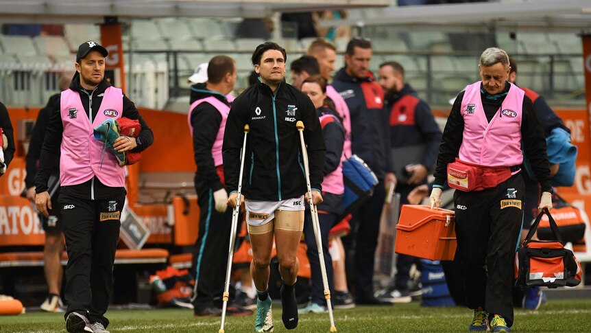 Chad Wingard of the Power (C) is seen on crutches after the round 18 game against Melbourne.