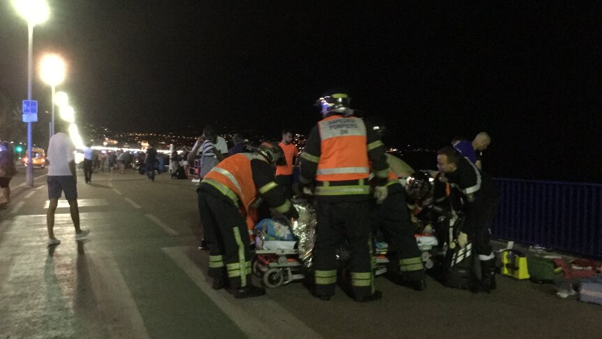 Medics attend to people injured when a truck reportedly crashed into a crowd of people in Nice.