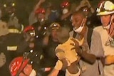 American police and firemen rescue two young children from the rubble in Haiti.