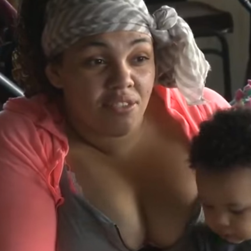 Erika Craycraft enjoys a meal at the wedding reception with her young child