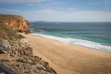 Cliffs, sand and surf at Ethel Beach in South Australia.