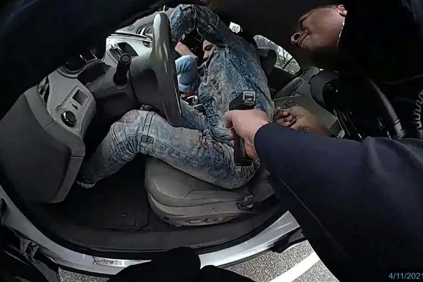 Body cam footage shows a gun being pointed at a motorist during a traffic stop.