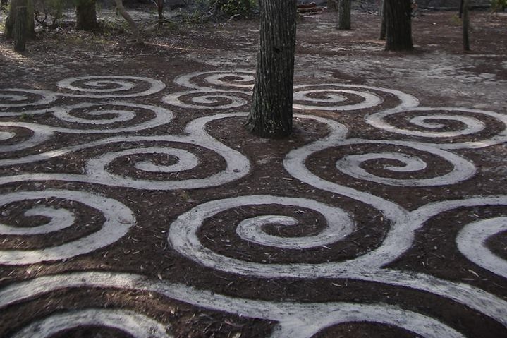 White sand underneath a layer of pine needles - sculptured into some spatterns