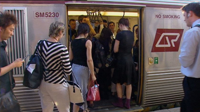 Generic TV still of commuters boarding a Qld Rail passenger train in Brisbane on Sept 1, 2008.