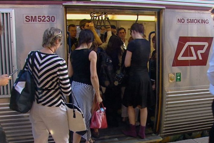 Generic TV still of commuters boarding a Qld Rail passenger train in Brisbane on Sept 1, 2008.