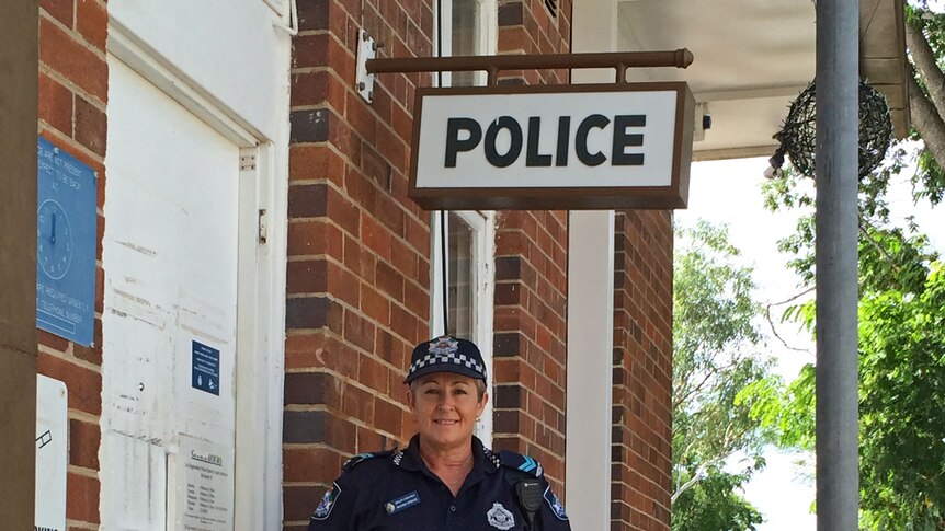 Female police officer in uniform stands outside a police station in Hughenden north west Queensland