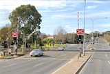 A car drives across an Adelaide level crossing.